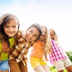 A group of young children are playing together outside.