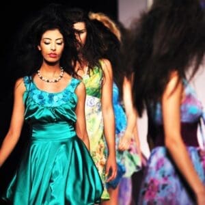 A group of women in dresses on the runway.